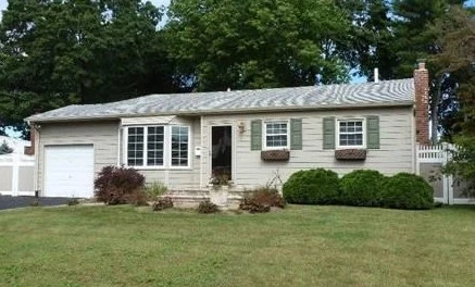 Ranch home with an attached garage in Commack, New York, listed and sold by Thomas Brady