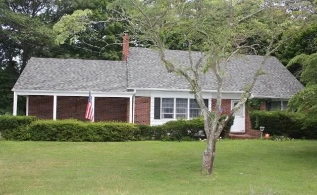Brick ranch home with a covered porch in Medford, New York, purchased by buyers Thomas Brady represented